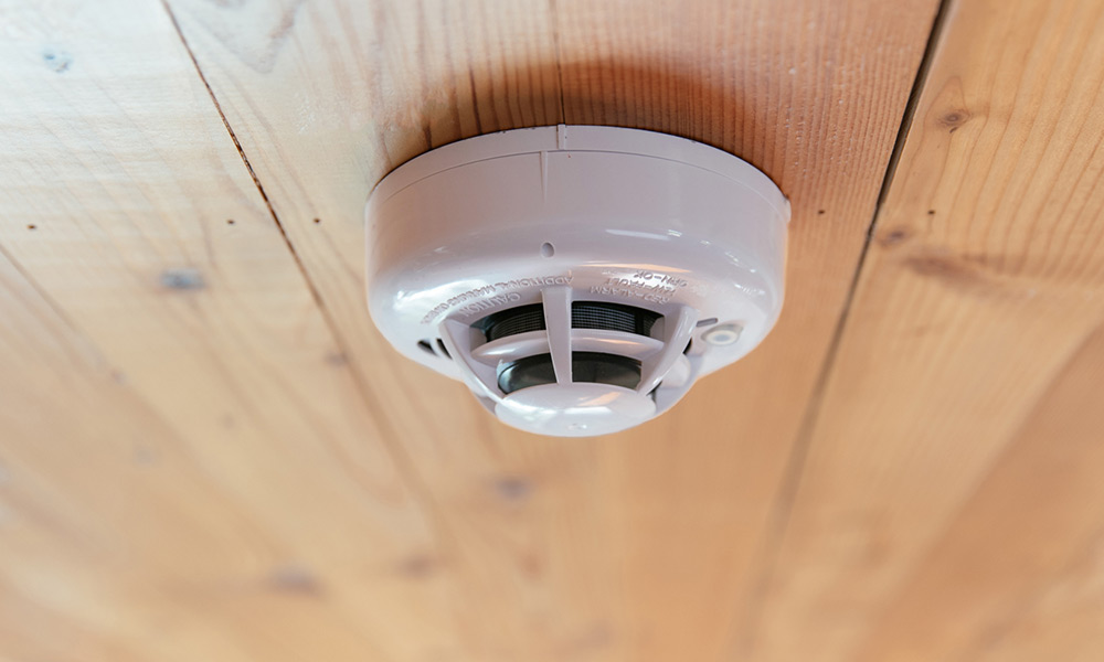 smoke-detector-wood-ceiling-closeup